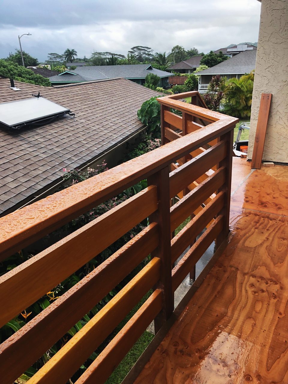 Horizontal-slat wood deck railing looking over rooftops