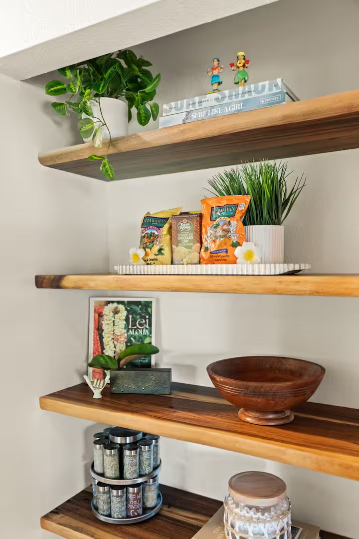 Live-edge floating wood shelves with books, plants and pantry jars