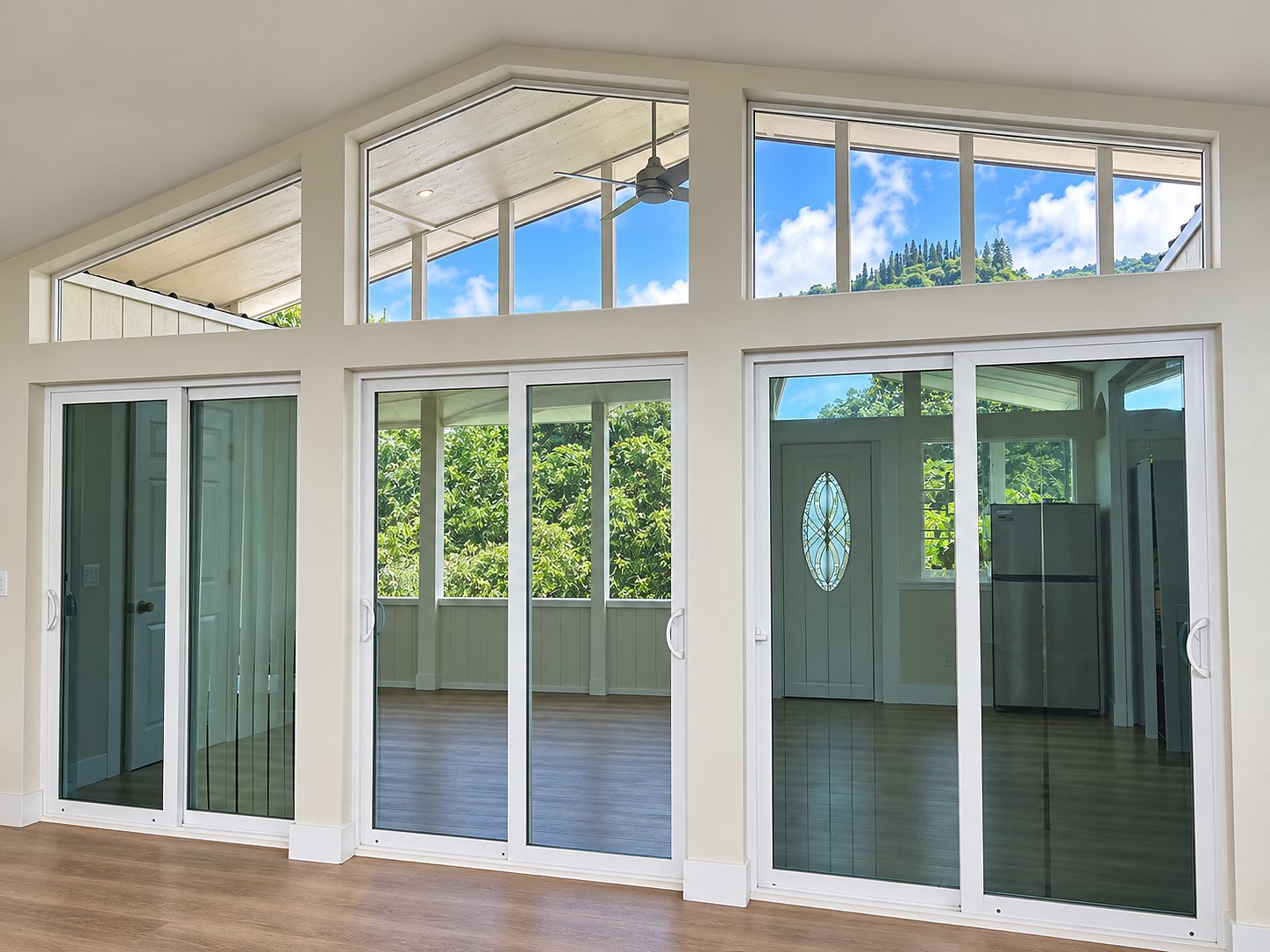 Family room with a wall of sliding glass doors and clerestory windows under the lifted roof