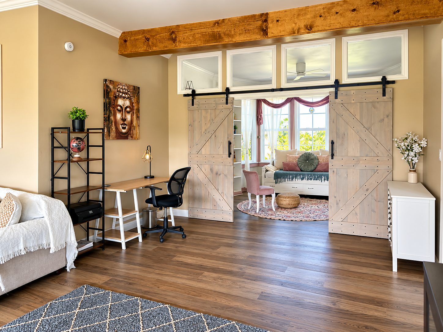 Family room with a beam ceiling and sliding barn doors to the next room