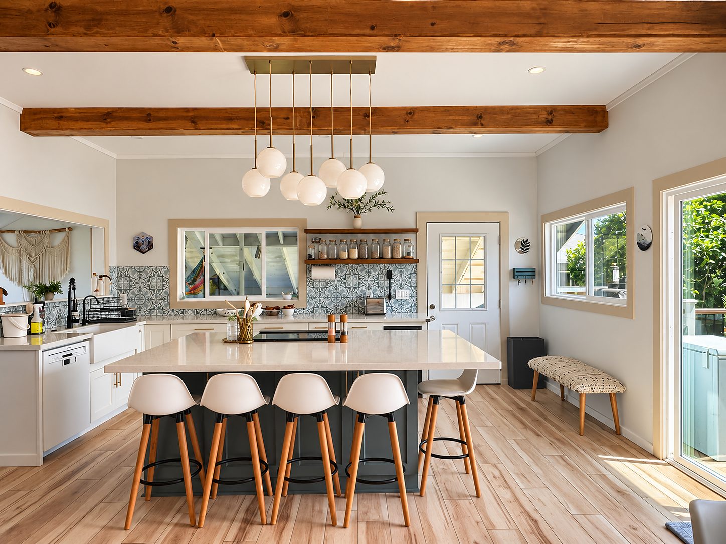 The kitchen from the dining side, with pendant lights and open shelving